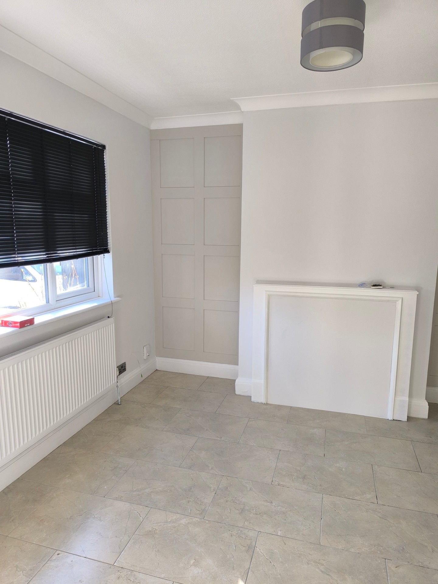 Refurbished interior room with fresh paint, new flooring and clean finishes